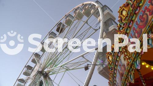 Carousel Is Spinning In Front Of The Ferris Wheel. Kilkenny. Ireland 2023